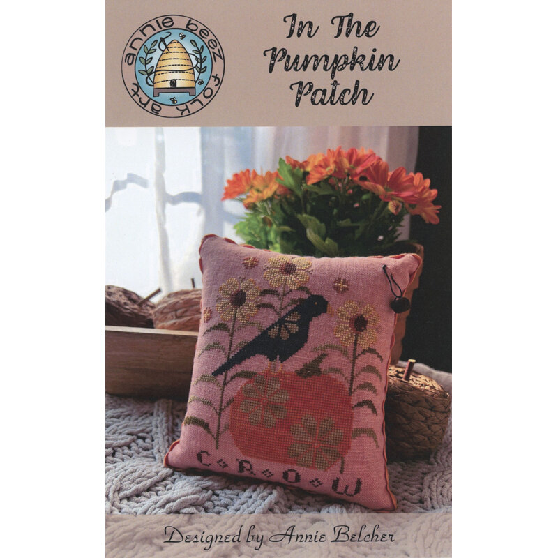 Decorative fall-themed cross-stitch pattern titled "in the pumpkin patch" with a crow perched on top of a pumpkin