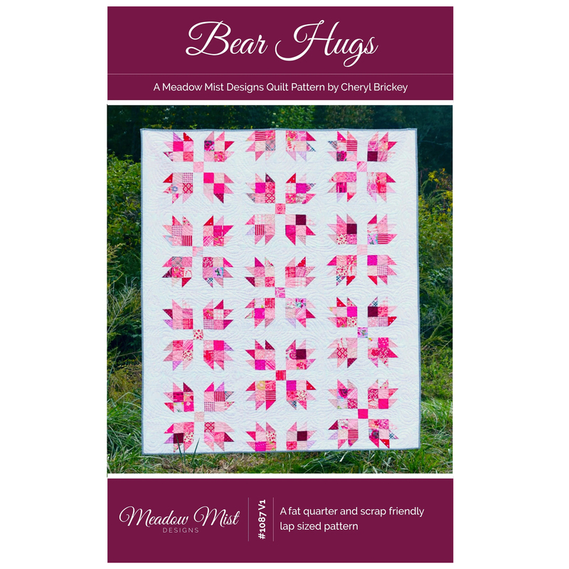 The front of the Bear Hugs pattern with photo of finished quilt staged in front of a grassy area.