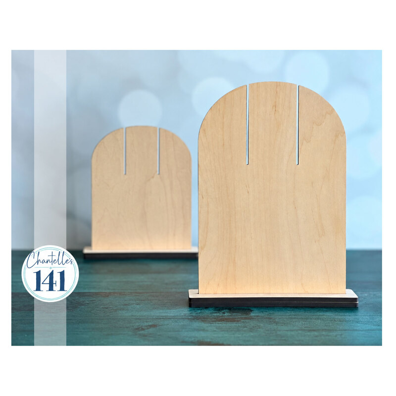 Two rounded display pieces on a teal surface against a blue background.