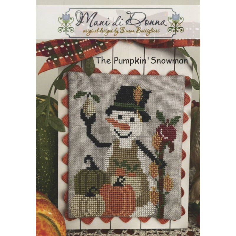 Cross-stitch pattern cover showing a snowman with pumpkins and a bird on a plaid background.
