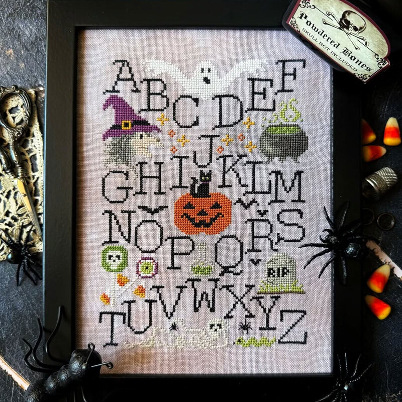 Finished pattern in a picture frame staged with halloween décor.