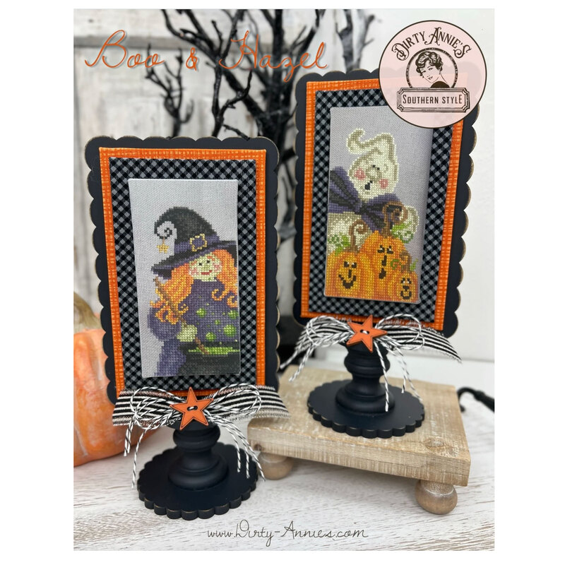 The two completed cross stitch projects of Boo and Hazel, set on a faded gray fabric and stitched with bright colors, displayed on a Paisleys and Polka Dots mount.