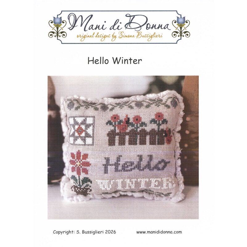 Cross stitch pillow pattern cover reading “Hello Winter” with a wintry-themed stitched cushion.