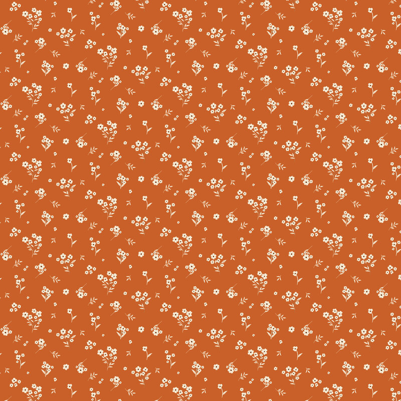 Dark orange fabric with a tossed design of white florals and leaves.