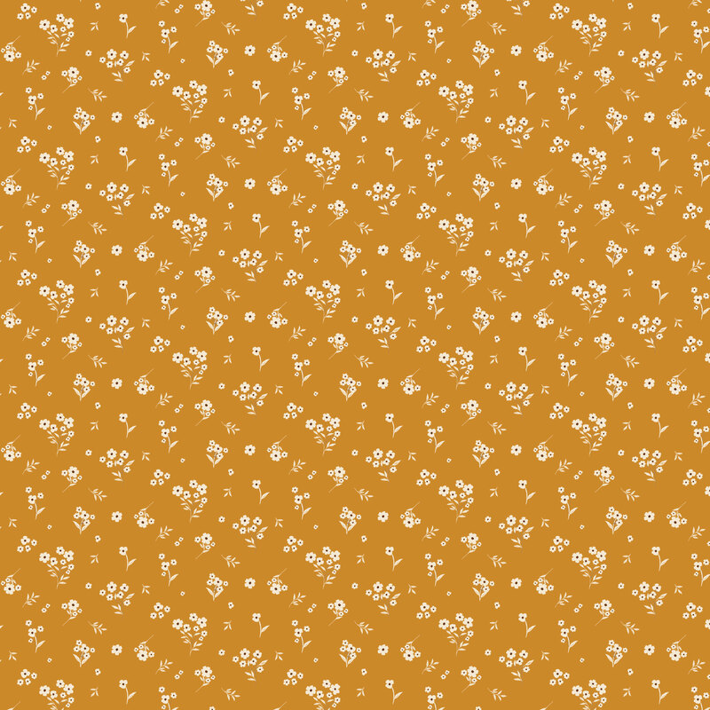 Amber yellow fabric with a tossed design of white florals and leaves.