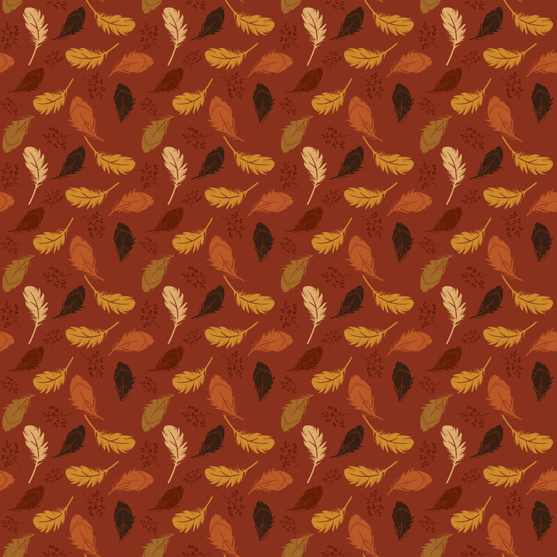 Deep terra cotta orange fabric with a pattern of tossed fall-colored feathers and leafy sprigs.