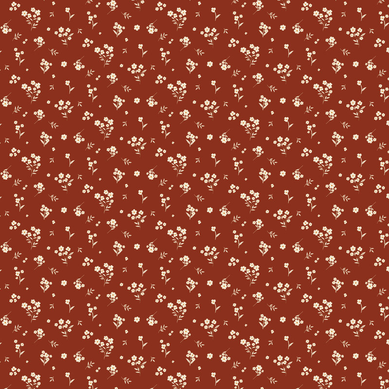 Dark terra cotta orange fabric with a tossed design of white florals and leaves.