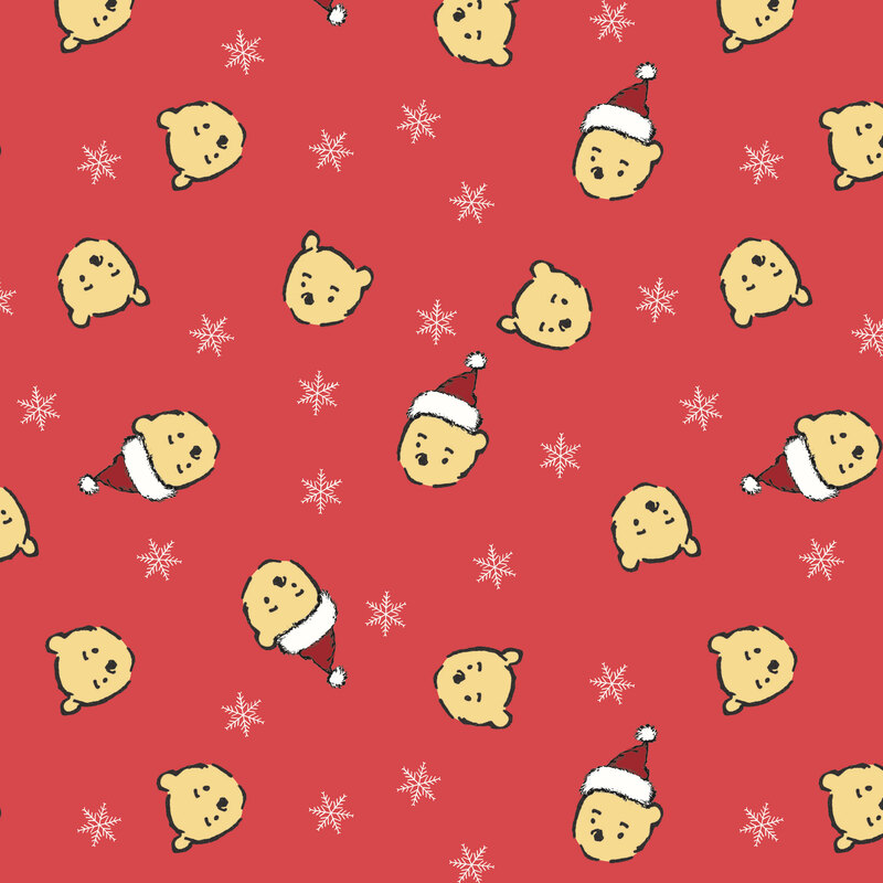 Christmas red fabric with a tossed design of white snowflakes and Pooh Bear heads wearing Santa hats.