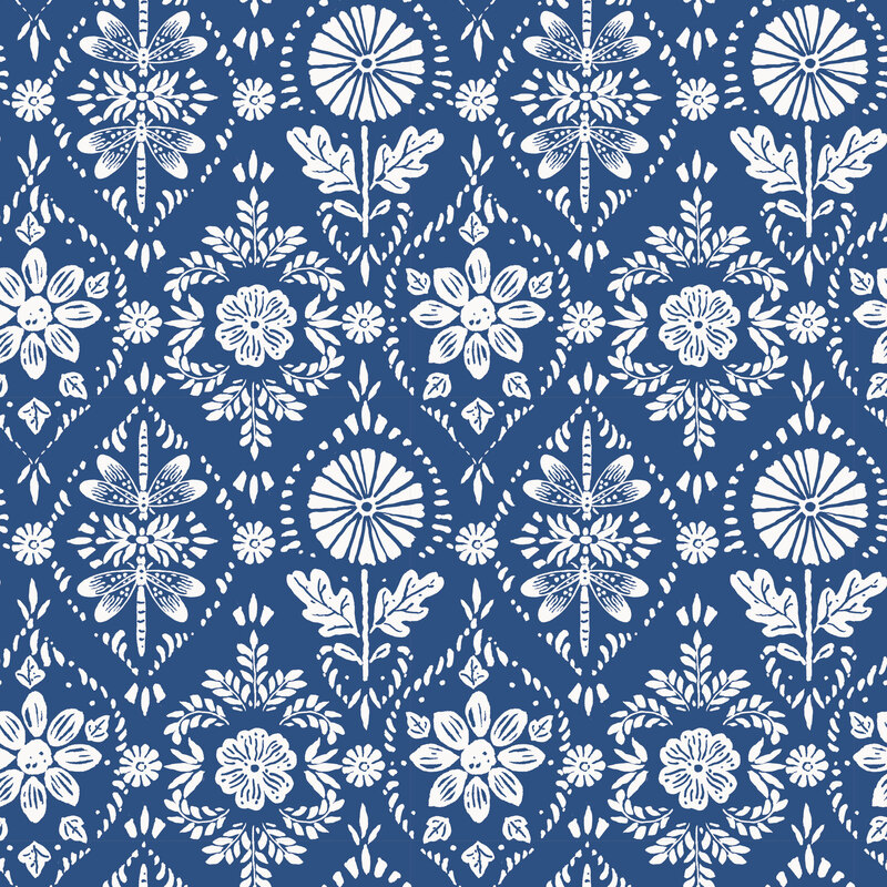 ornamental fabric featuring white stylized sunflowers, leaves, and dragonflies on a navy blue background.