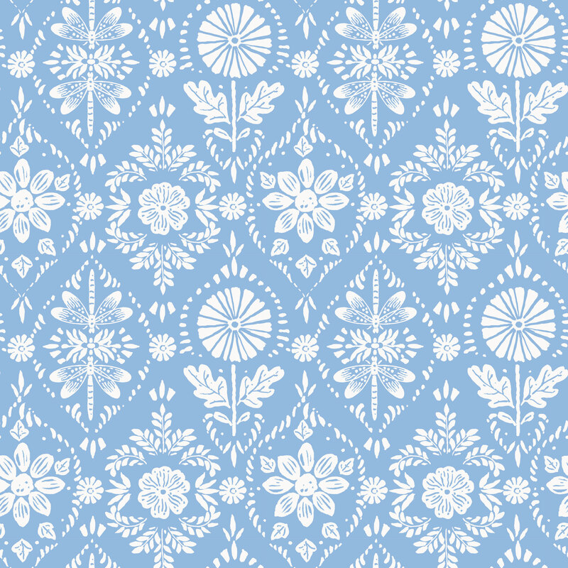 ornamental fabric featuring white stylized sunflowers, leaves, and dragonflies on a light blue background.