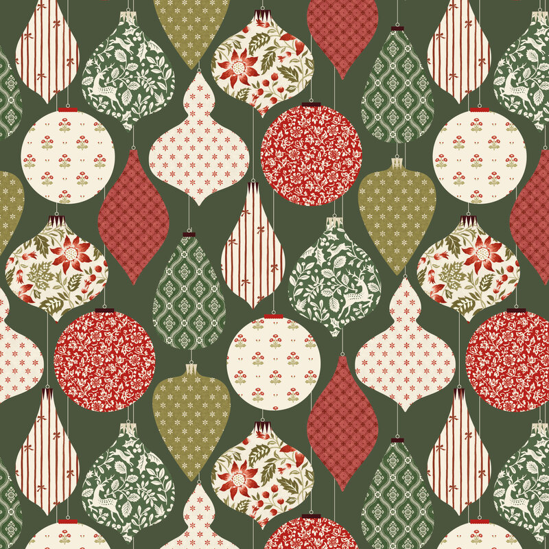 A dark sage green fabric with hanging christmas ornaments filled with festive florals, deer, stars, and stripes.