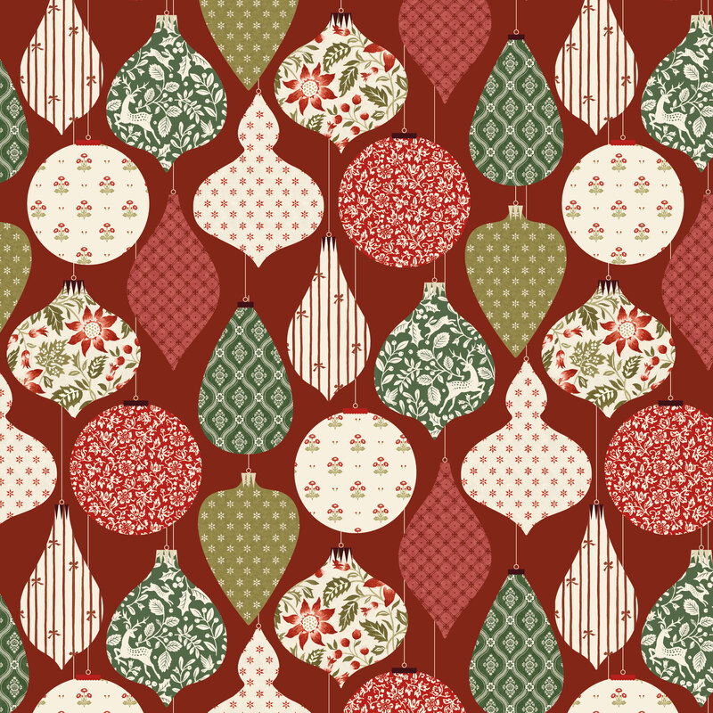 A crimson red fabric with hanging Christmas ornaments filled with festive florals, deer, stars, and stripes.