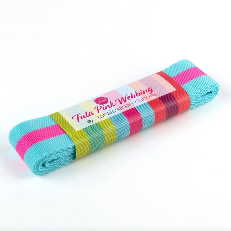 Aqua and pink webbing with a colorful label reading Tula Pink Webbing by Renaissance Ribbons.
