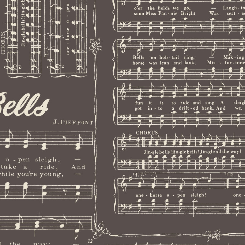 Graphite gray fabric with a scattered design of the Jingle Bells song in a white color and bordered by holly vines.