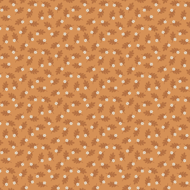Ocher-orange fabric with a tossed pattern of burnt sienna leaves accented with white stars.
