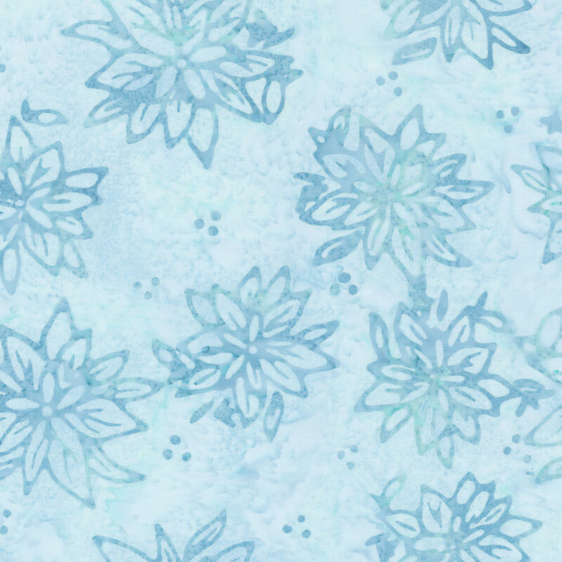 Mottled blue batik fabric with a tossed pattern of florals.