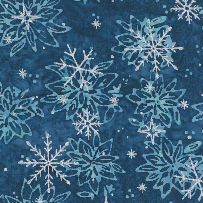 Mottled navy blue batik with a tossed floral pattern accented with scattered silver metallic winter motifs.