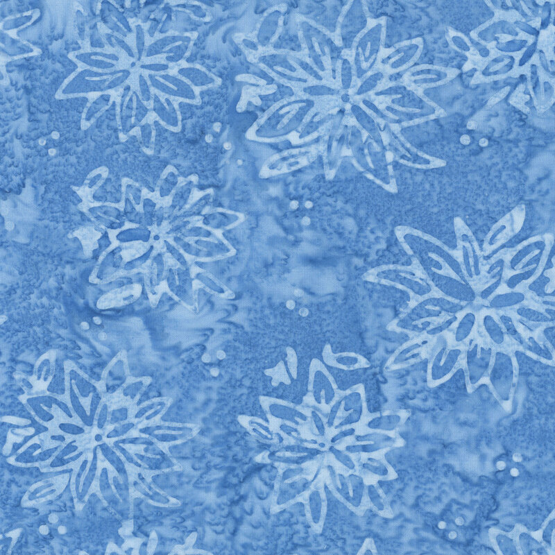 Mottled blue batik fabric with a tossed pattern of tonal florals.