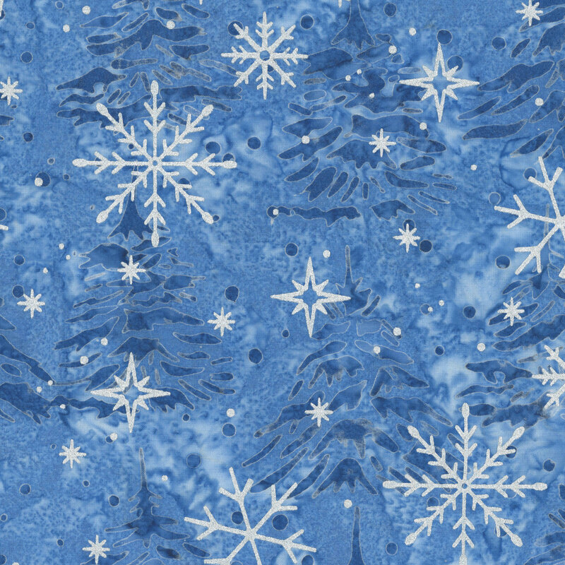 Mottled blue batik fabric with a tossed pattern of pine trees accented with scattered metallic winter motifs.