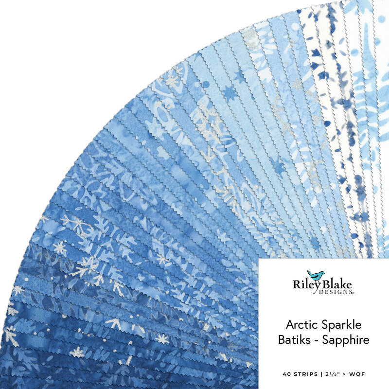 Blue batik fabric swatch with snowflake pattern and label “Arctic Sparkle Batiks - Sapphire”
