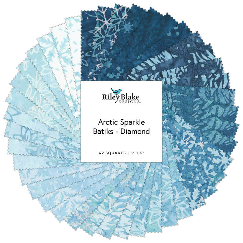 Stack of blue-and-white quilt fabric squares labeled “Arctic Sparkle Batiks - Diamond”