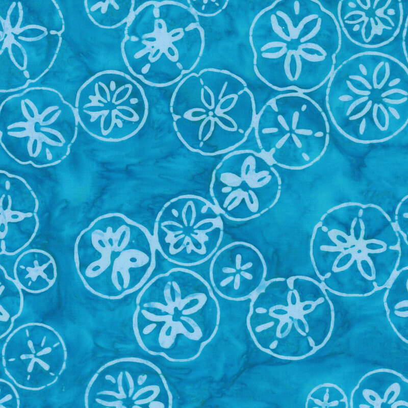 mottled cerulean blue fabric featuring scattered sand dollar motifs.