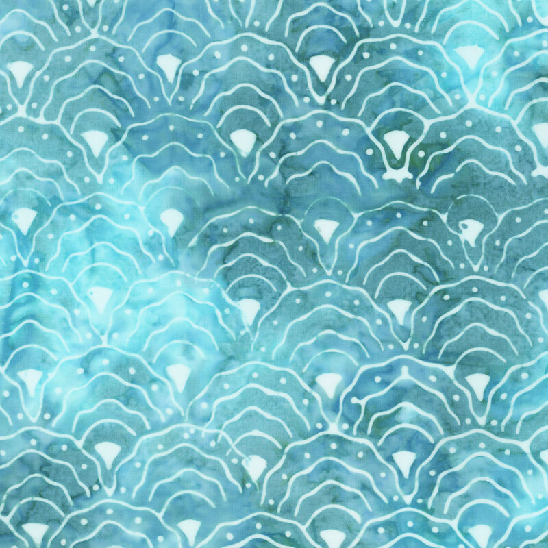 light aqua and smoky teal mottled fabric with a repeating pattern of scalloped fan motifs in white