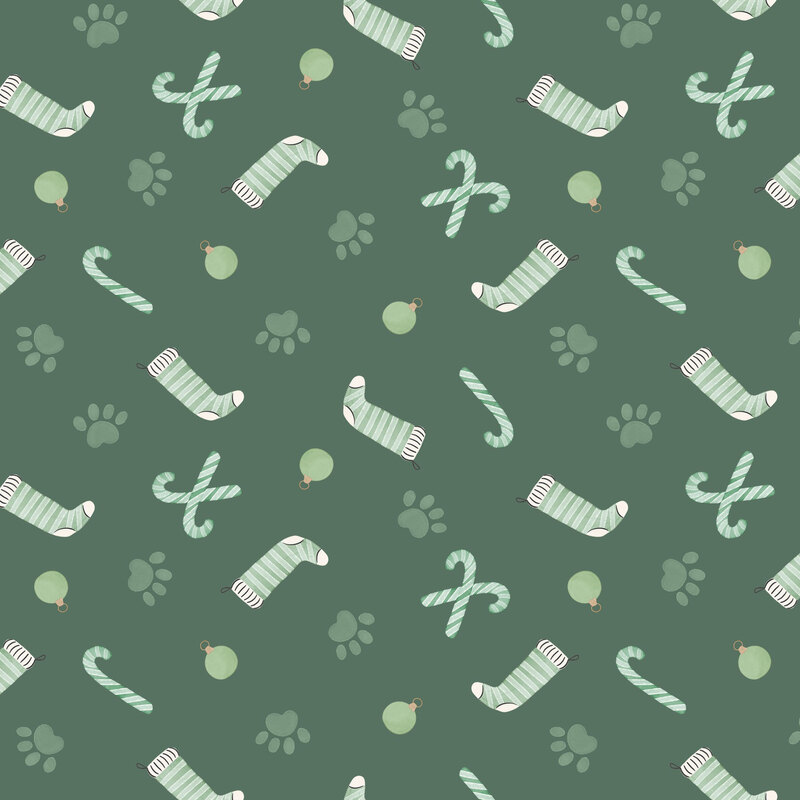 Muted green fabric with a tossed pattern of soft green red paw prints, candy canes, stockings, and ornaments.