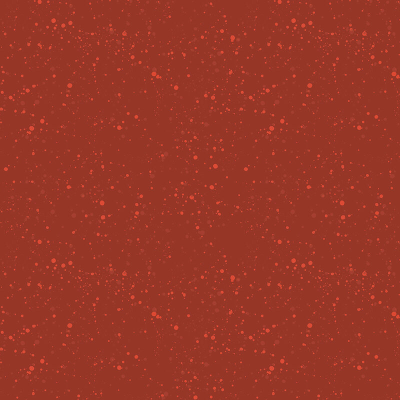 Terra cotta red fabric with a pattern of speckled light and soft red dots.