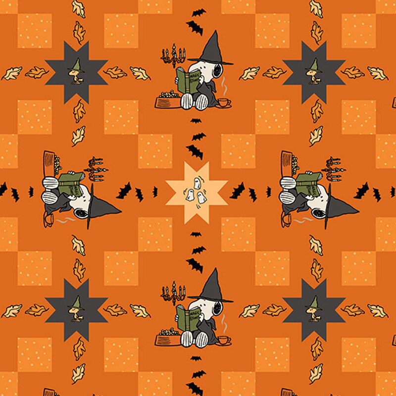 An orange cheater fabric with snoopy and woodstock alongside leaves, ghosts, and bats.