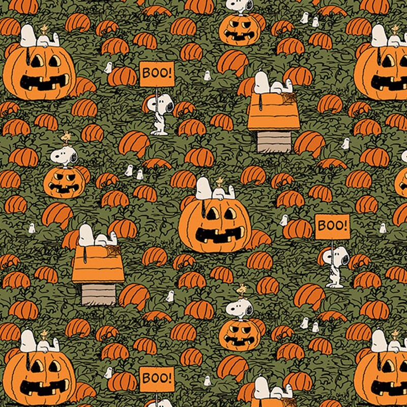 A dark sage green fabric featuring snoopy and woodstock among a pumpkin patch.