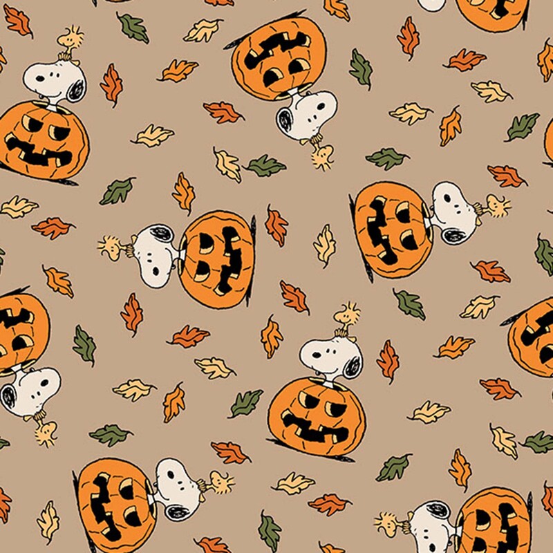 A latte fabric with Snoopy and Woodstock inside a jack-o'-lantern among scattered fall leaves. 