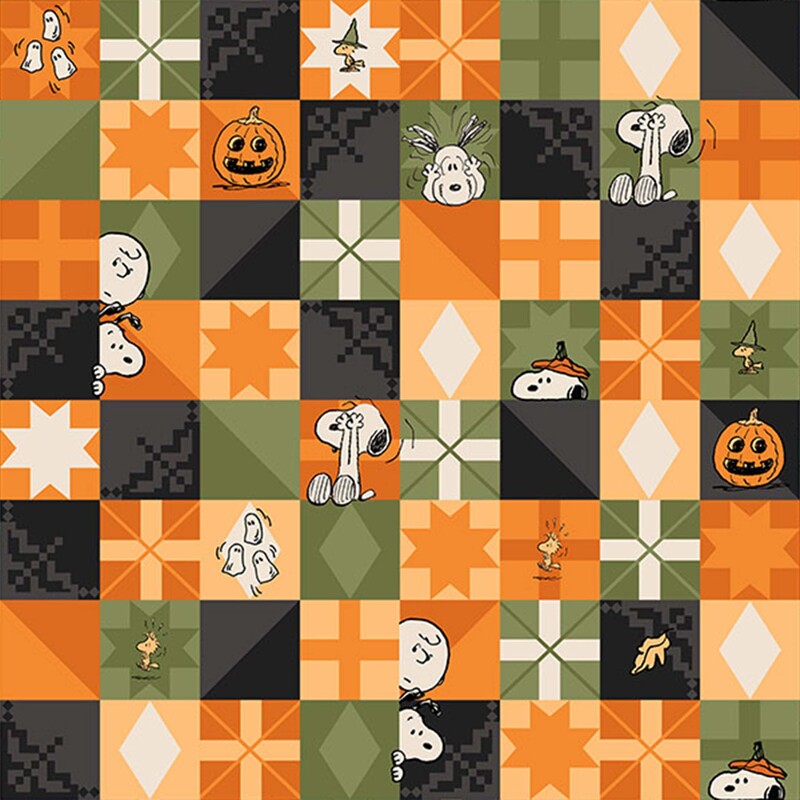 A multicolored fabric with Snoopy, Charlie Brown, Woodstock, pumpkins, ghosts, and geometric motifs arranged in patchwork-style squares.