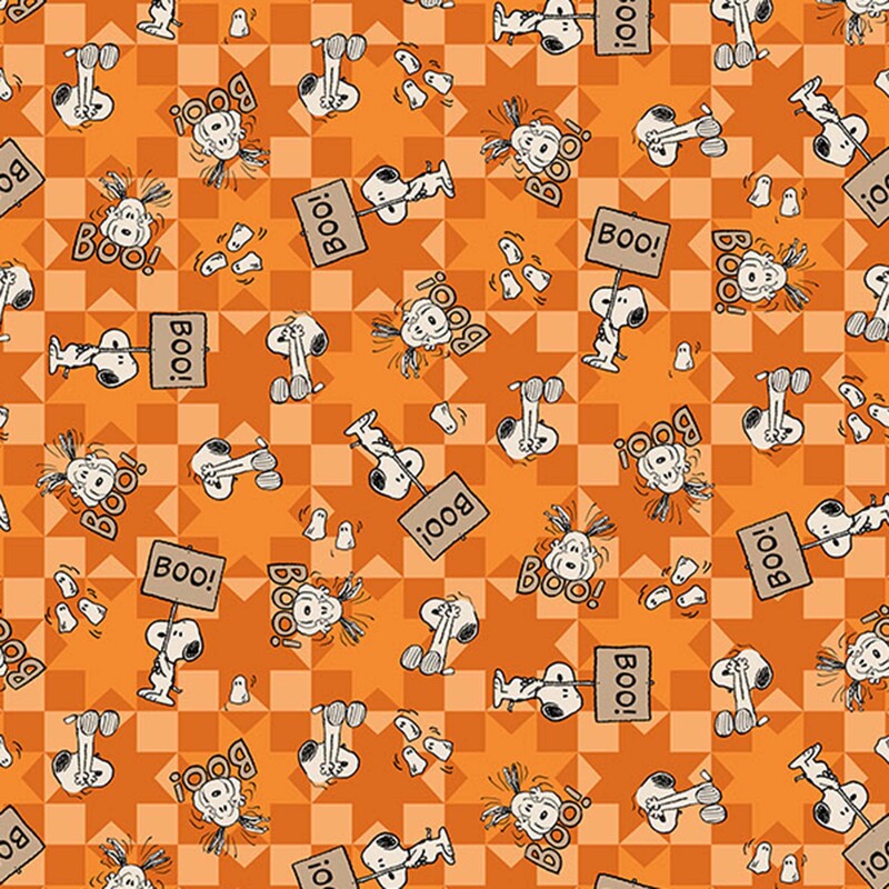 An orange fabric with tossed Snoopy illustrations and playful ghosts over sawtooth star blocks.