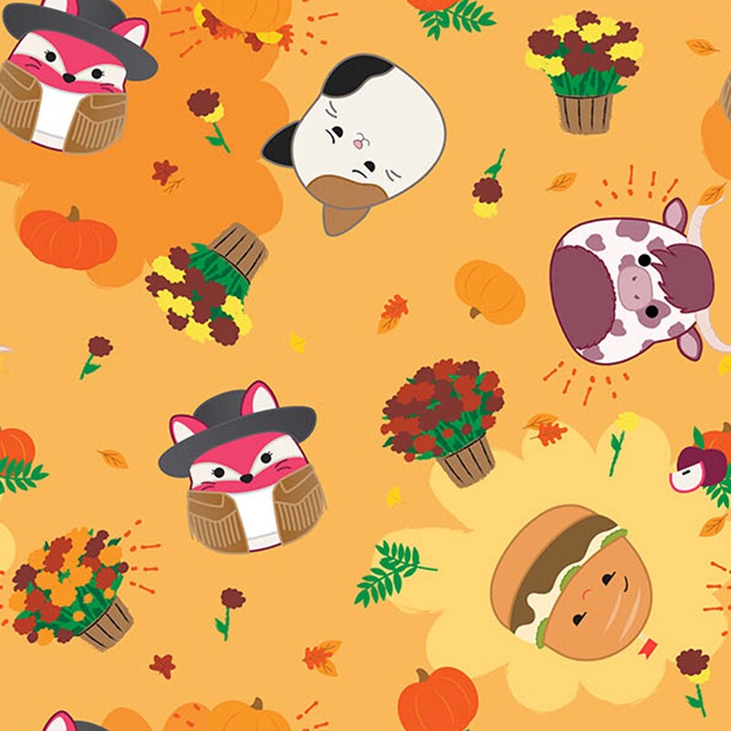 Honey yellow fabric features a tossed design of fall motifs and animal and food Squishmallows.