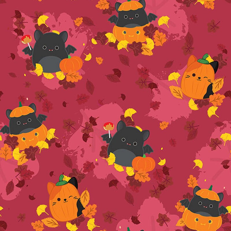 Merlot fabric with a pattern of splotchy and tossed leaves with scattered scenes of bat and pumpkin Squishmallows in beds of fall motifs.
