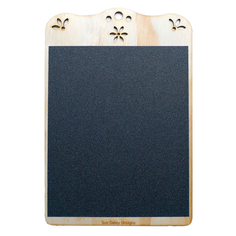 Rectangular fabric tracing board with a textured sandpaper surface designed to hold fabric steady while marking template shapes.