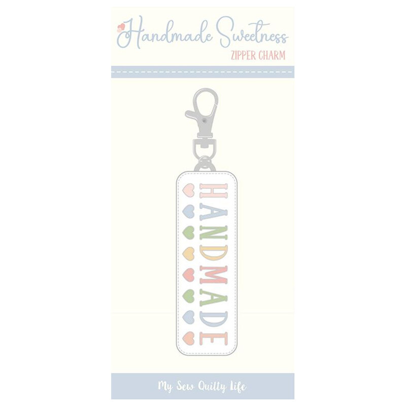 Hard enamel zipper charm with decorative “Handmade” lettering and a metal lobster claw clasp.
