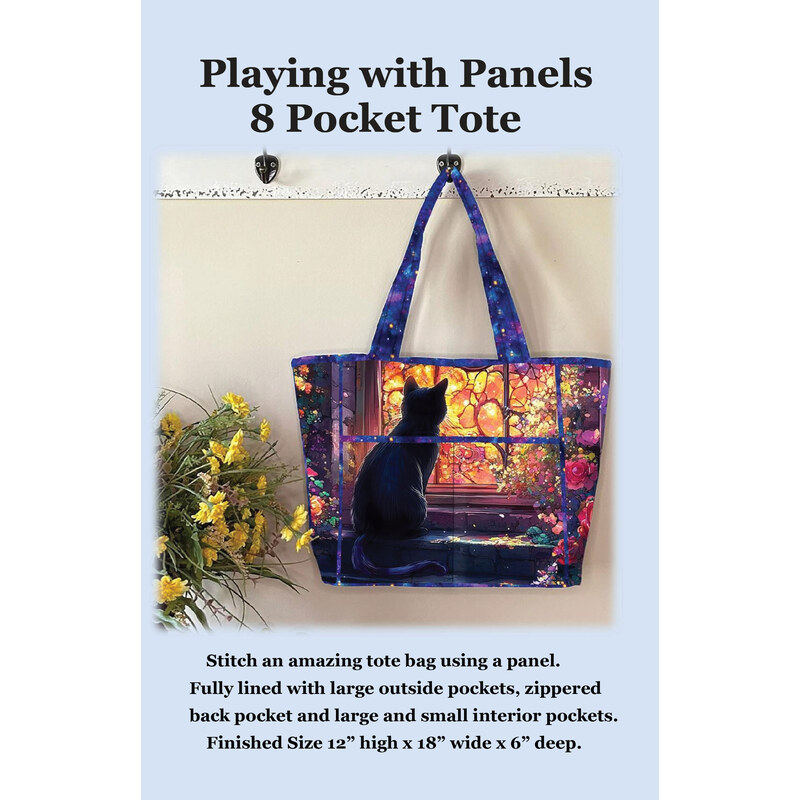Front cover of the pattern showing the completed tote made with a colorful cat-themed panel, staged against a wall with coordinating flowers.