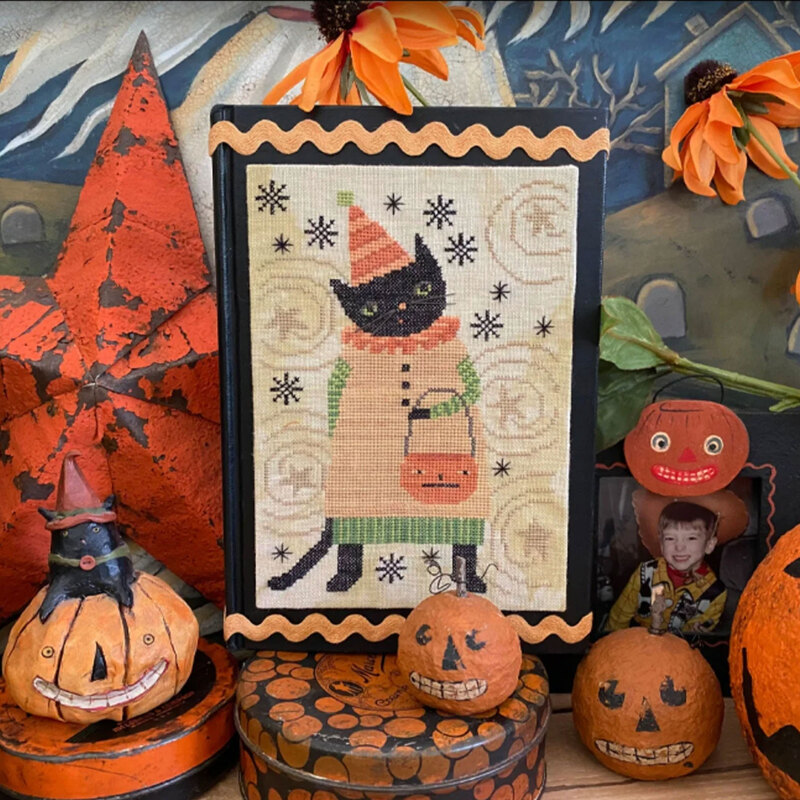 Finished project, staged in a black frame with seasonal background accents.