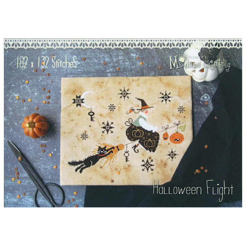 Front of the pattern displaying the finished project staged on a textured surface with pumpkins and scissors.