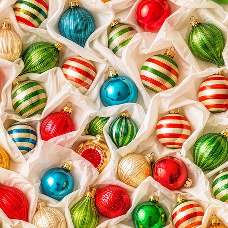 Cream fabric of glass Christmas ornaments in blue, red, and green, gently held by tissue paper.