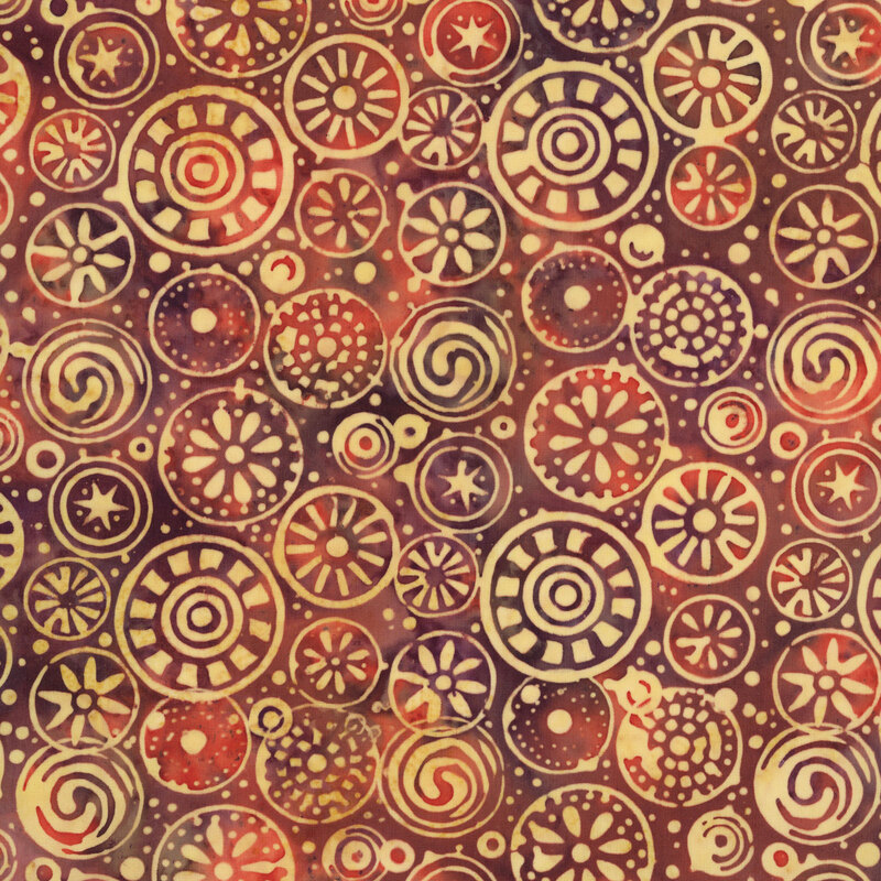 plum and rust batik fabric featuring geometric, spiral, and floral medallions over a softly mottled background with buff-toned accent dots.