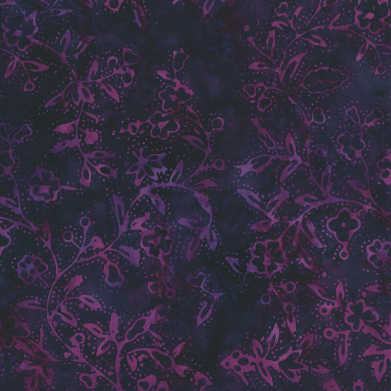 batik fabric featuring delicate floral vines, leafy branches, and tiny blossoms in rich shades of violet and passion purple against a deeply mottled indigo background.