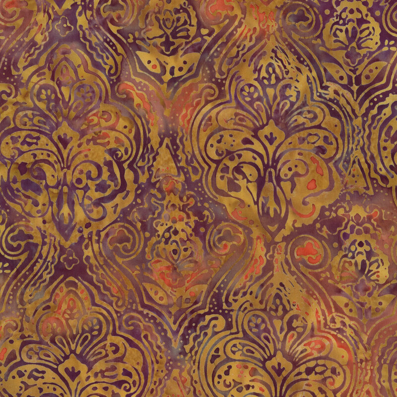 batik fabric featuring damask-inspired floral motifs and swirling scrollwork in rich shades of golden amber, against a rust orange and deep plum background