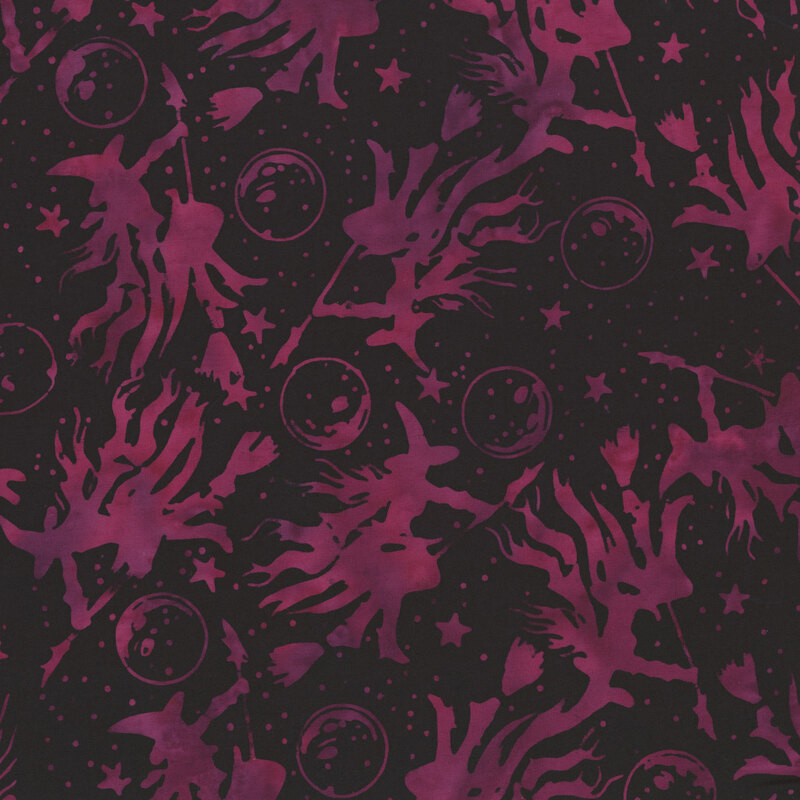 mottled magenta witches on brooms scattered across a black night sky accented with stars and moons.