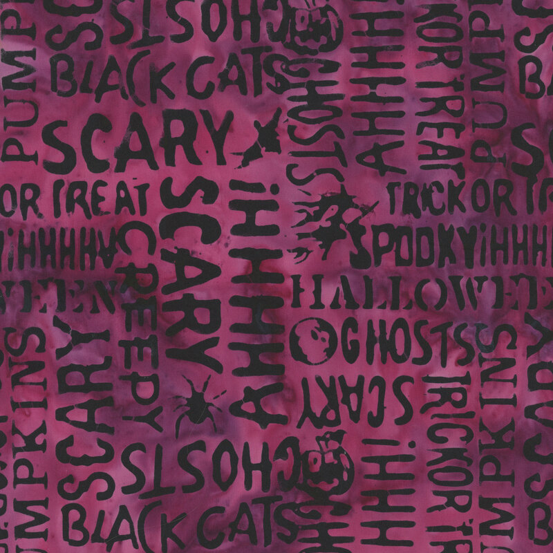 mottled magenta fabric featuring Halloween-themed words and motifs.