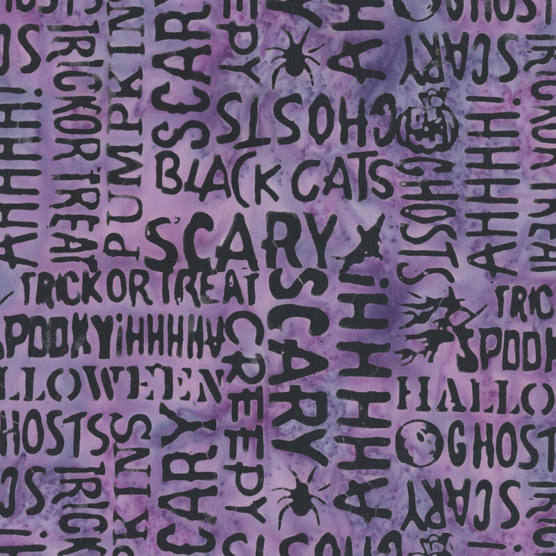 mottled heather purple fabric featuring Halloween-themed words and motifs.