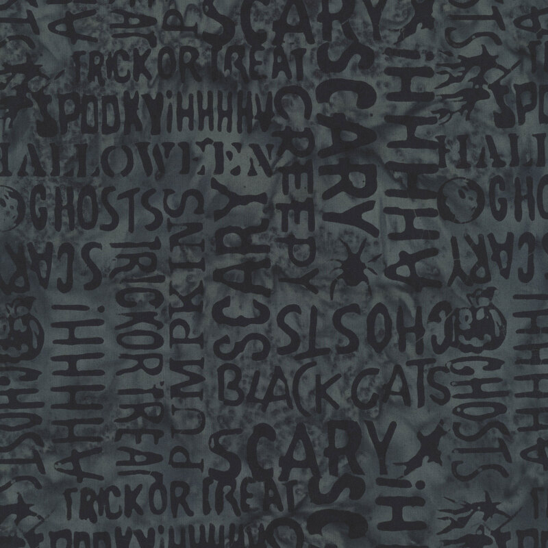 mottled charcoal fabric featuring Halloween-themed words and motifs.