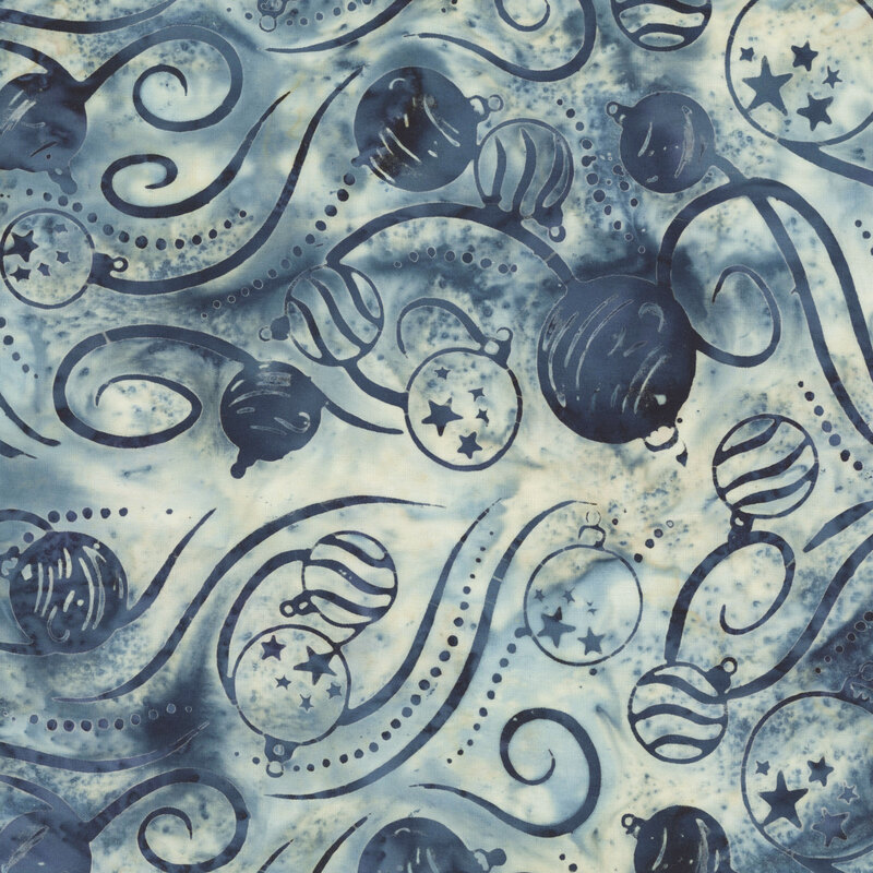 cream and navy mottled batik fabric featuring festive ornaments accented by dotted lines and swirling ribbons in dark navy hues.